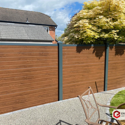 Recently Fitted - EnduroFence in Darkwood Woodgrain effect - Small U-Rib Panel Design - With Complete Steel Post Covers and Top Fence Caps finished in Anthracite Grey - 2
